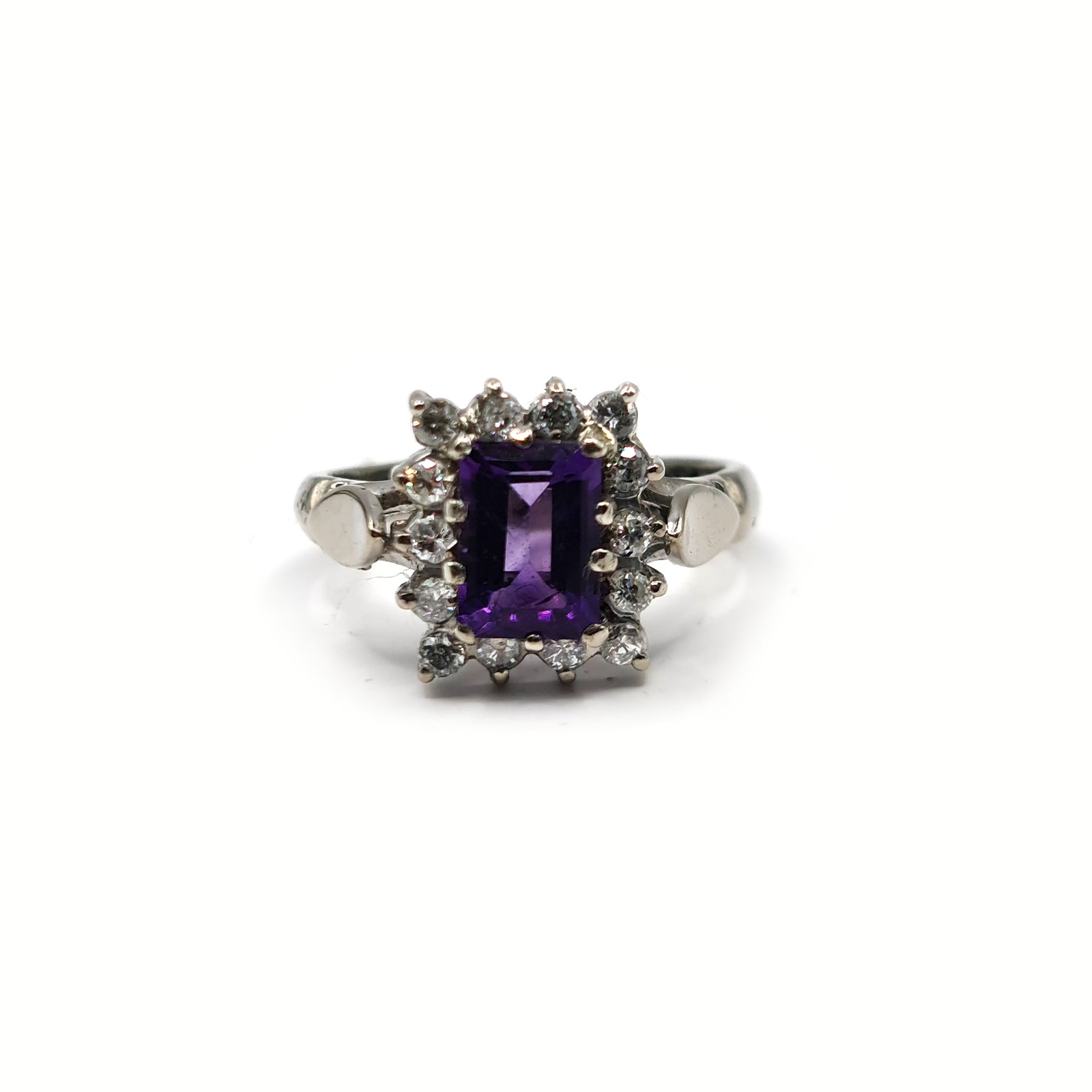 18ct white gold ring with a 1.05 carat emerald cut amethyst and 0.30 carat diamond accents, showcasing elegant jewelry design.