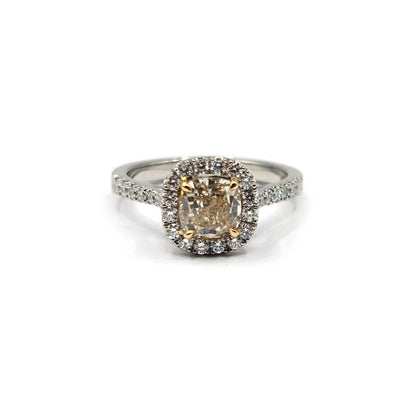 18ct white gold ring featuring a 1.15 carat fancy yellow diamond and a 0.60 carat diamond halo, with VS1 clarity.