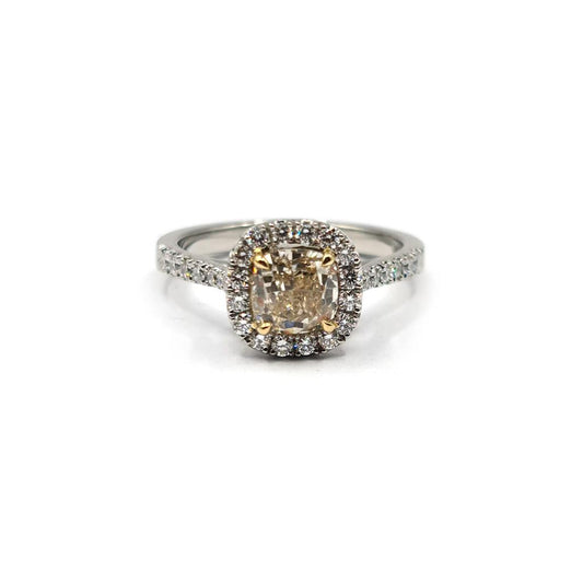 18ct white gold ring featuring a 1.15 carat fancy yellow diamond and a 0.60 carat diamond halo, with VS1 clarity.