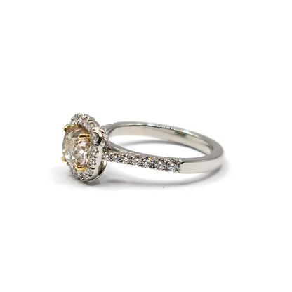 18ct white gold ring with a 1.15 carat fancy yellow diamond and a 0.60 carat diamond halo, featuring VS1 clarity.