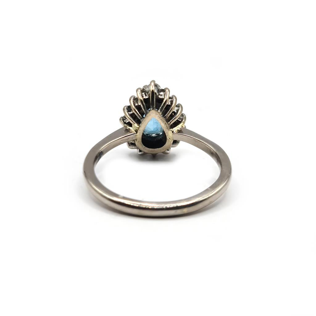 18ct white gold ring featuring a 1.90 carat pear-shaped topaz and 0.40 carat diamonds, elegant jewelry piece with intricate design