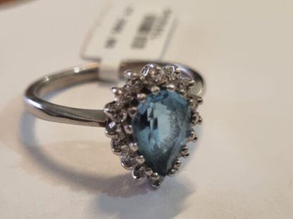 18ct white gold ring featuring a 1.90 carat pear-shaped topaz and 0.40 carat diamonds, elegant jewelry with intricate design.