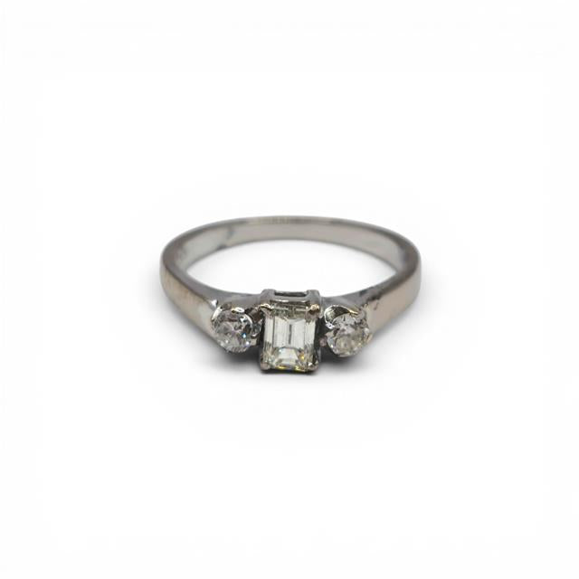 18ct white gold ring with three sparkling diamonds, elegant jewelry design, unbranded, photographed on a neutral background.