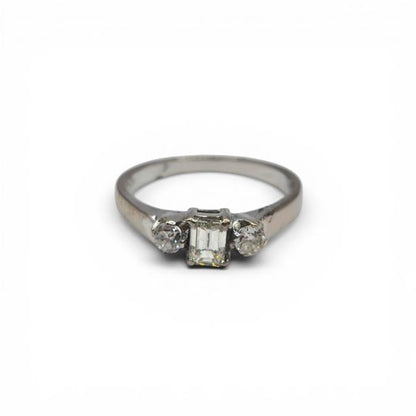 18ct white gold ring with three sparkling diamonds, elegant jewelry design, unbranded, photographed on a neutral background.