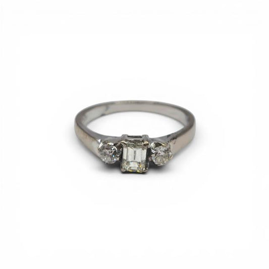 18ct white gold ring with three sparkling diamonds, elegant jewelry design, unbranded, photographed on a neutral background.