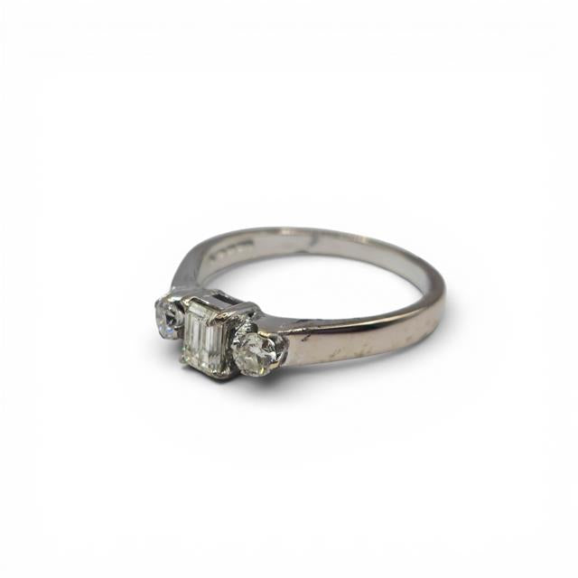 18ct white gold ring with three sparkling diamonds, elegant jewelry piece with a sleek design and polished finish.