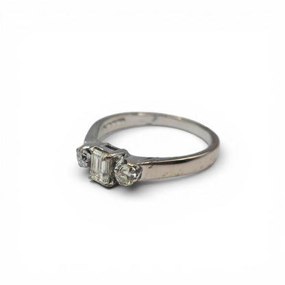 18ct white gold ring with three sparkling diamonds, elegant jewelry piece with a sleek design and polished finish.