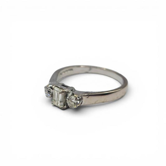 18ct white gold ring with three sparkling diamonds, elegant jewelry piece with a sleek design and polished finish.
