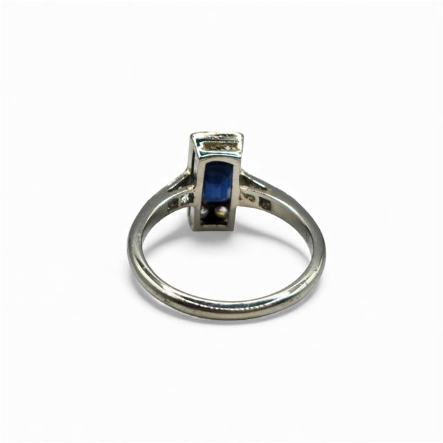 18ct white gold and platinum ring featuring diamonds and sapphires, displayed with intricate gemstone details.