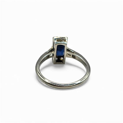 18ct white gold and platinum ring featuring diamonds and sapphires, displayed with intricate gemstone details.