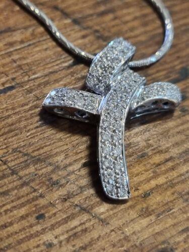 18ct white gold chain with a diamond twist cross pendant featuring 0.65 carats of diamonds, elegant jewelry accessory.