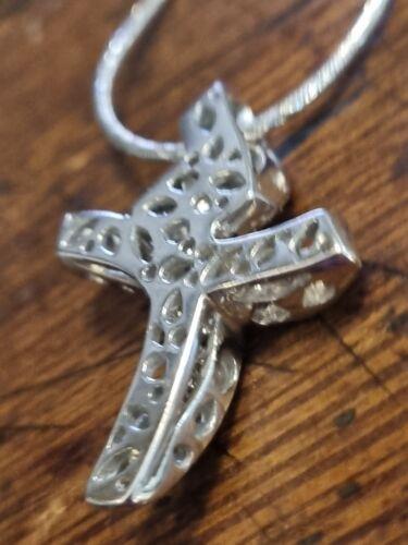18ct white gold chain with a 0.65 carat diamond twist cross pendant, elegant jewelry accessory.