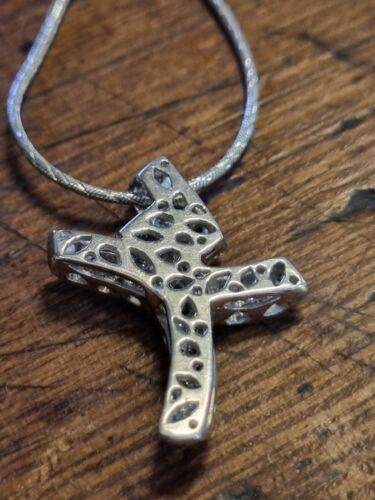 18ct white gold chain featuring a 0.65 carat diamond twist design cross pendant, showcasing elegant jewelry craftsmanship.