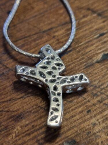 18ct white gold chain with 0.65 carat diamond twist cross pendant, showcasing elegant jewelry design and sparkling gemstones.