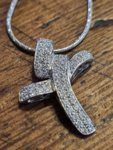 18ct white gold chain featuring a twist design cross with 0.65 carat diamonds, showcasing elegant craftsmanship.