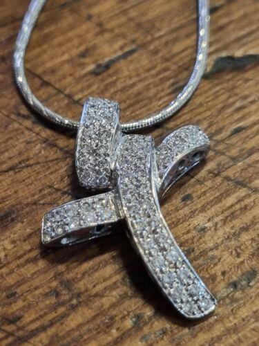 18ct white gold chain with a 0.65 carat diamond twist cross pendant, showcasing elegant jewelry design.