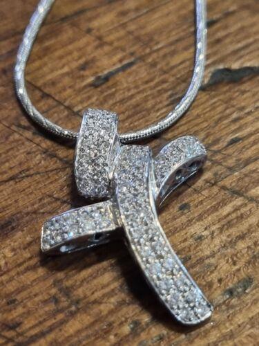 18ct white gold chain with 0.65 carat diamond twist design cross, showcasing elegant jewelry craftsmanship.