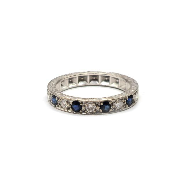 18ct white gold diamond and sapphire half eternity ring featuring alternating gemstones and a delicate band design.