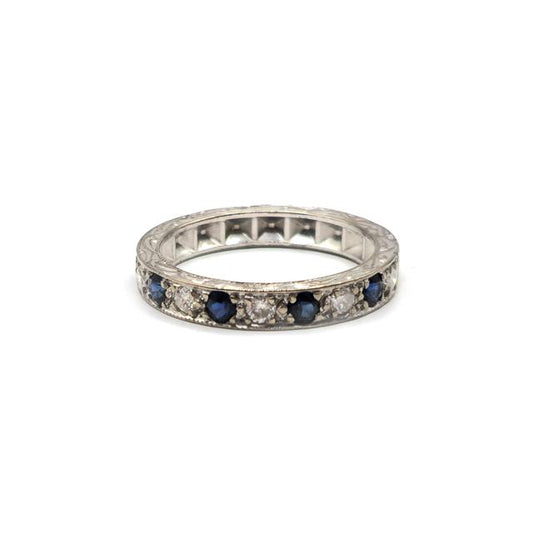 18ct white gold diamond and sapphire half eternity ring featuring alternating gemstones and a delicate band design.