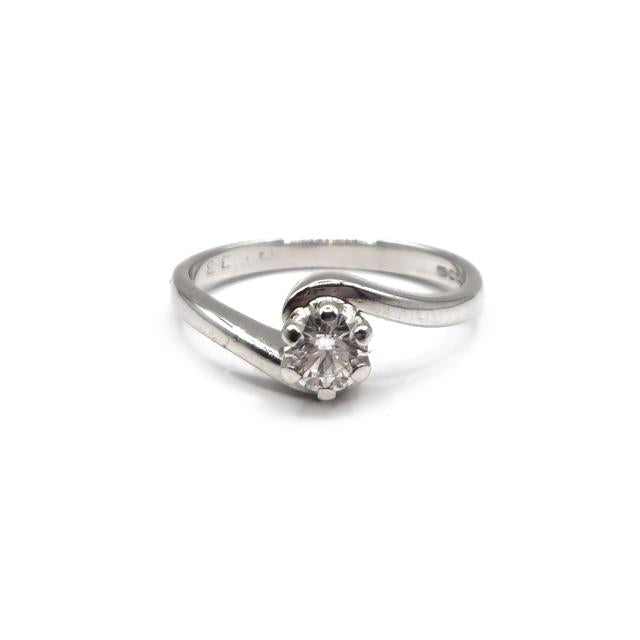 18ct white gold diamond ring with a central diamond and side stones, showcasing elegant jewelry design.