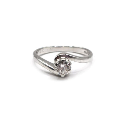 18ct white gold diamond ring with a central diamond and side stones, showcasing elegant jewelry design.