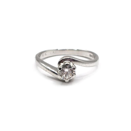 18ct white gold diamond ring with a central diamond and side stones, showcasing elegant jewelry design.