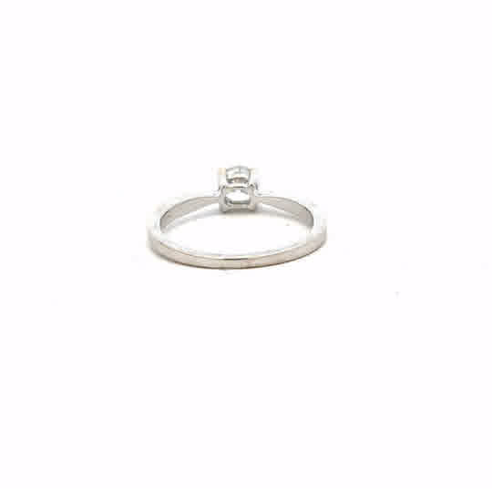 18ct white gold ring size J1/2 with a smooth band, unbranded jewelry, shown from a side angle on a plain background.