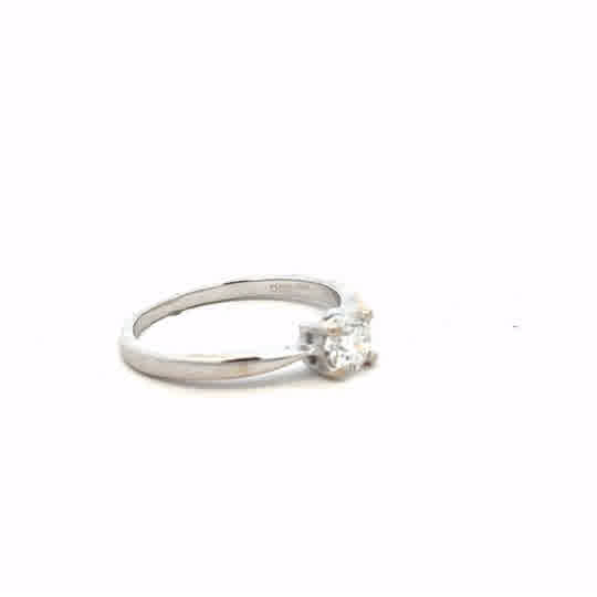 18ct white gold ring in size J1/2 with a smooth band, shown on a plain background, unbranded jewelry accessory.