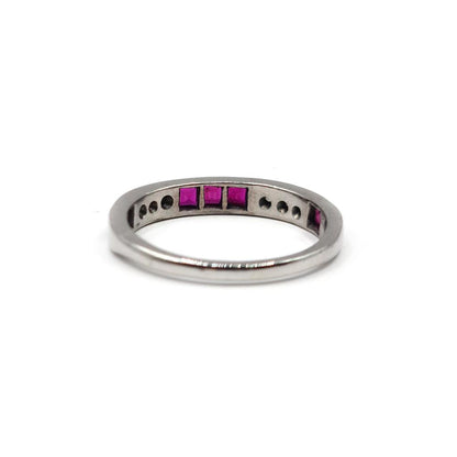 18ct white gold ruby and diamond half eternity ring with alternating gemstones and elegant design.