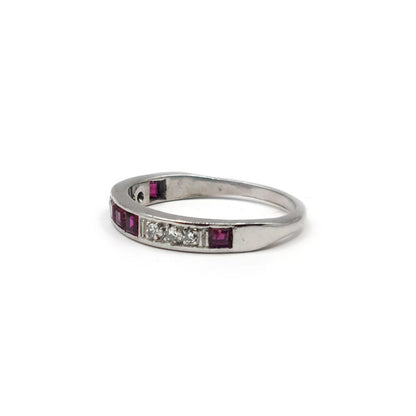 18ct white gold ruby and diamond half eternity ring with alternating gemstones and elegant design.