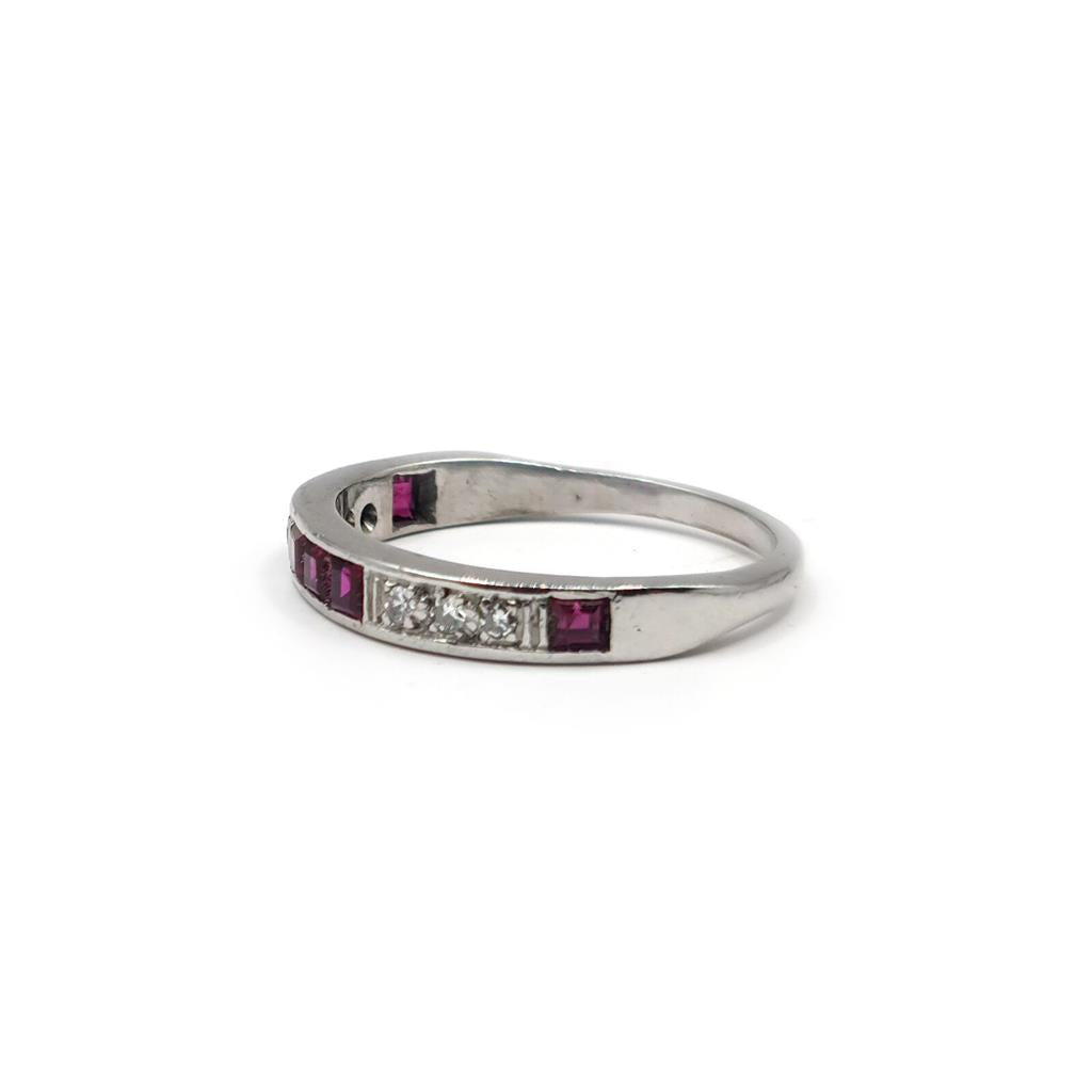 18ct white gold ruby and diamond half eternity ring with alternating gemstones and a sleek band design.