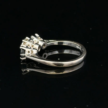 18ct white gold sapphire and diamond ring showcasing a central blue sapphire with sparkling diamonds on a sleek band.