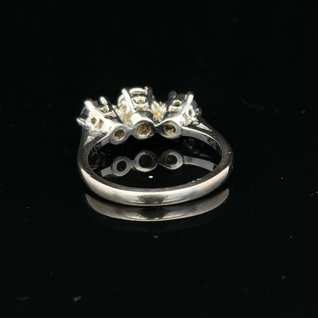 18ct white gold sapphire and diamond ring with a central blue sapphire and sparkling diamonds on a delicate band.