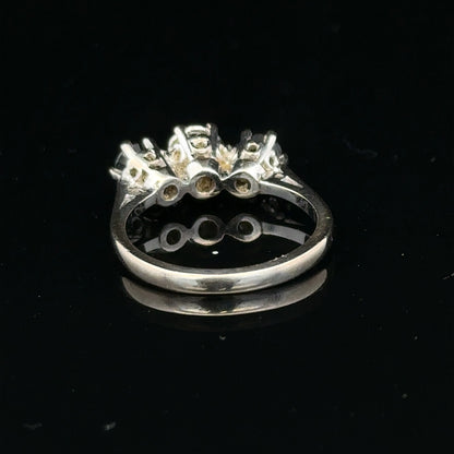 18ct white gold sapphire and diamond ring with a central blue sapphire and sparkling diamonds on a delicate band.