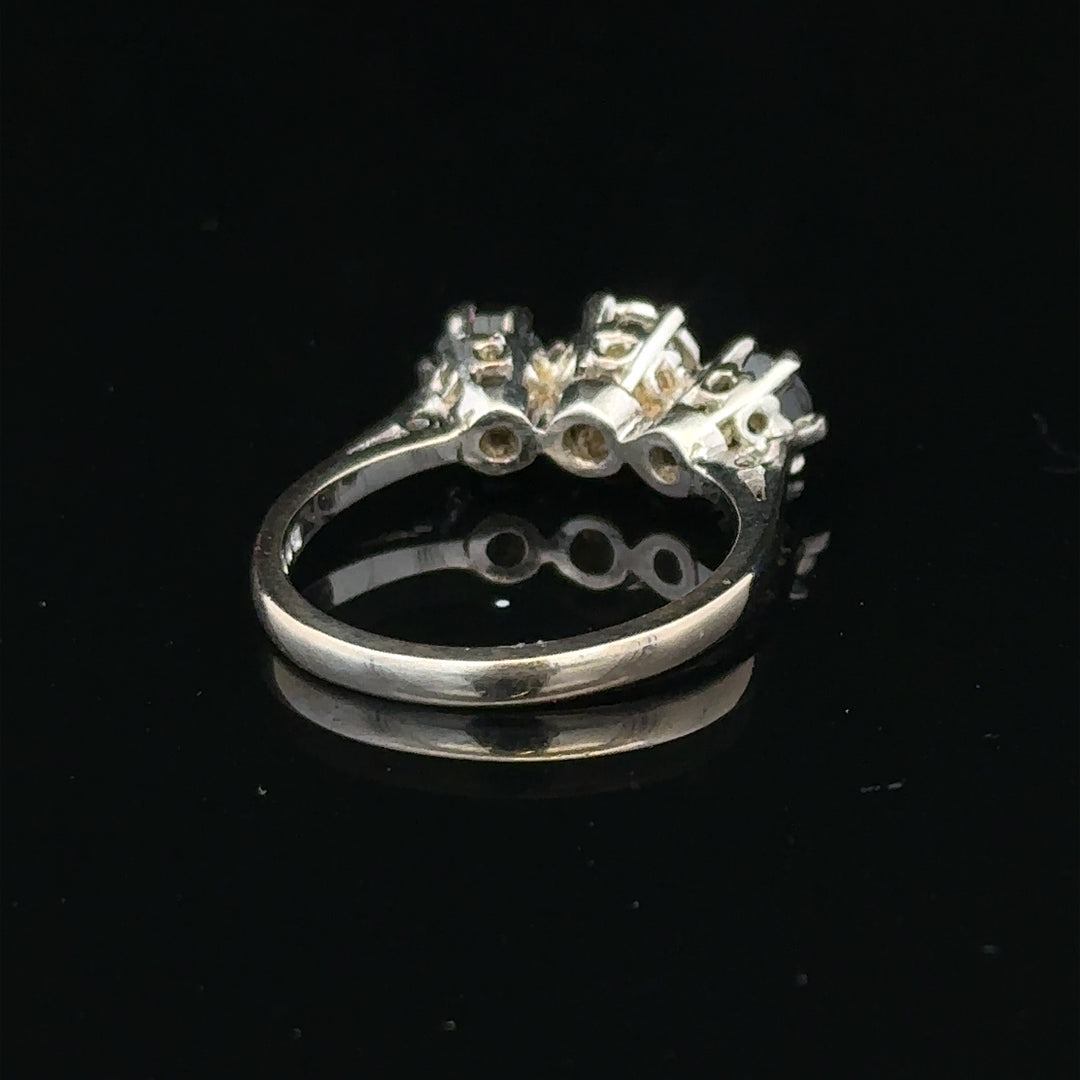 18ct white gold sapphire and diamond ring with a central blue sapphire surrounded by sparkling diamonds.