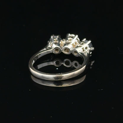 18ct white gold sapphire and diamond ring with a central blue sapphire surrounded by sparkling diamonds.
