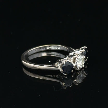 18ct white gold sapphire and diamond ring featuring a central blue sapphire surrounded by sparkling diamonds.