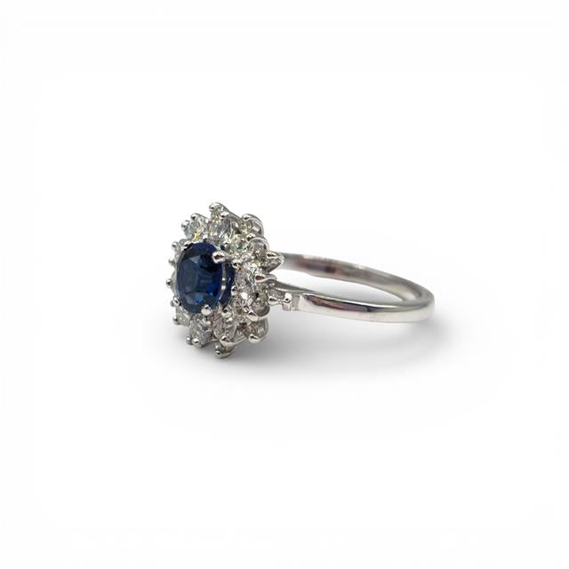 18ct white gold sapphire and diamond ring with a central blue sapphire and sparkling diamonds, elegant jewelry design.