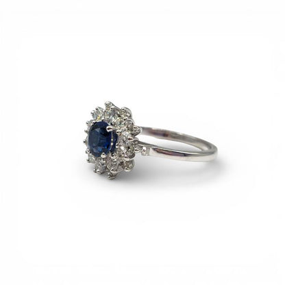 18ct white gold sapphire and diamond ring with a central blue sapphire and sparkling diamonds, elegant jewelry design.