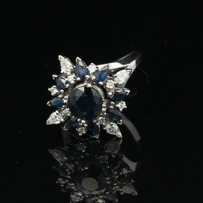 18ct white gold sapphire and diamond ring, size N1/2, featuring a central blue sapphire surrounded by sparkling diamonds.
