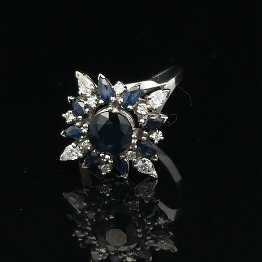 18ct white gold sapphire and diamond ring, size N1/2, featuring a central blue sapphire surrounded by sparkling diamonds.