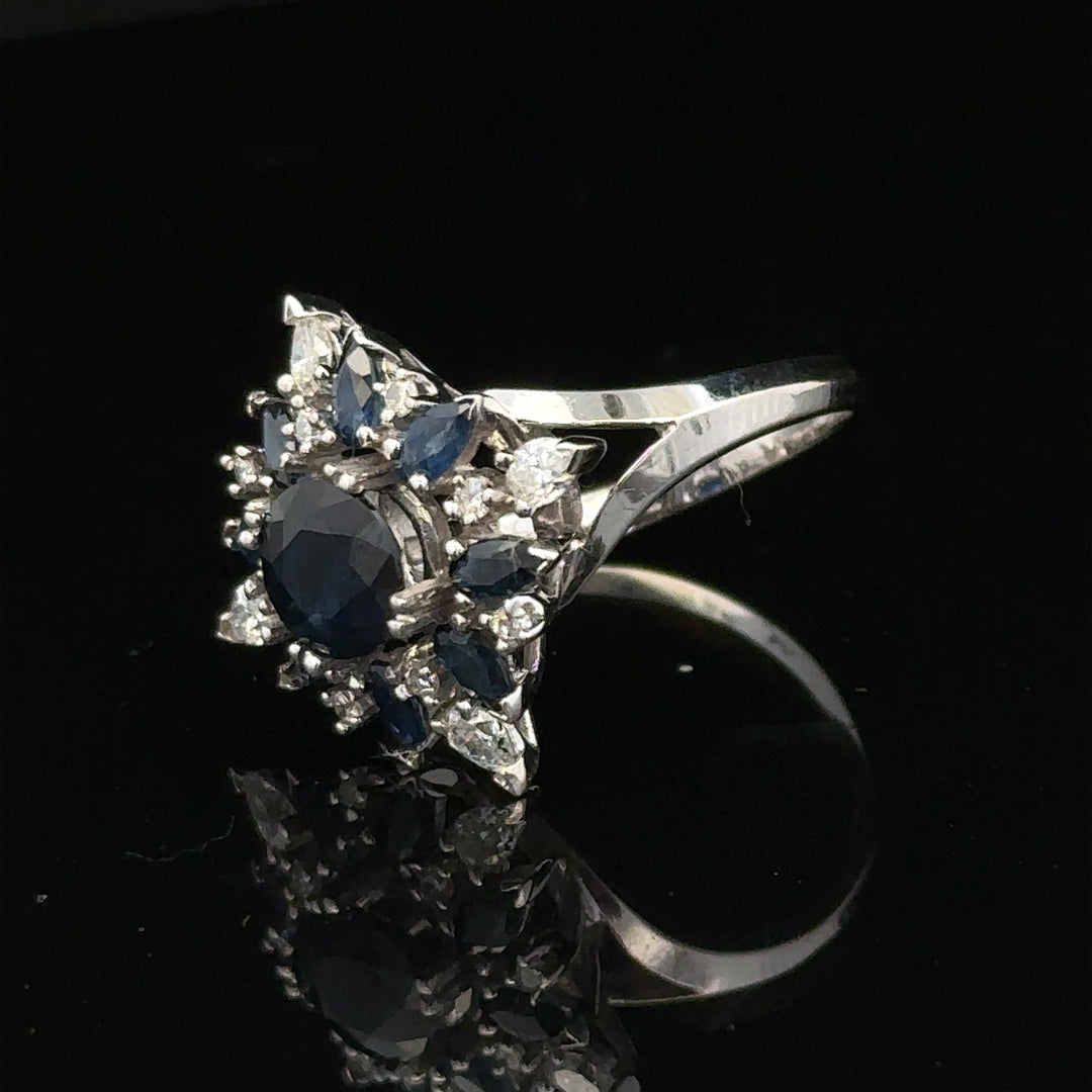 18ct white gold sapphire and diamond ring in size N1/2, featuring a central sapphire surrounded by sparkling diamonds.