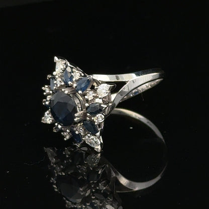 18ct white gold sapphire and diamond ring in size N1/2, featuring a central sapphire surrounded by sparkling diamonds.
