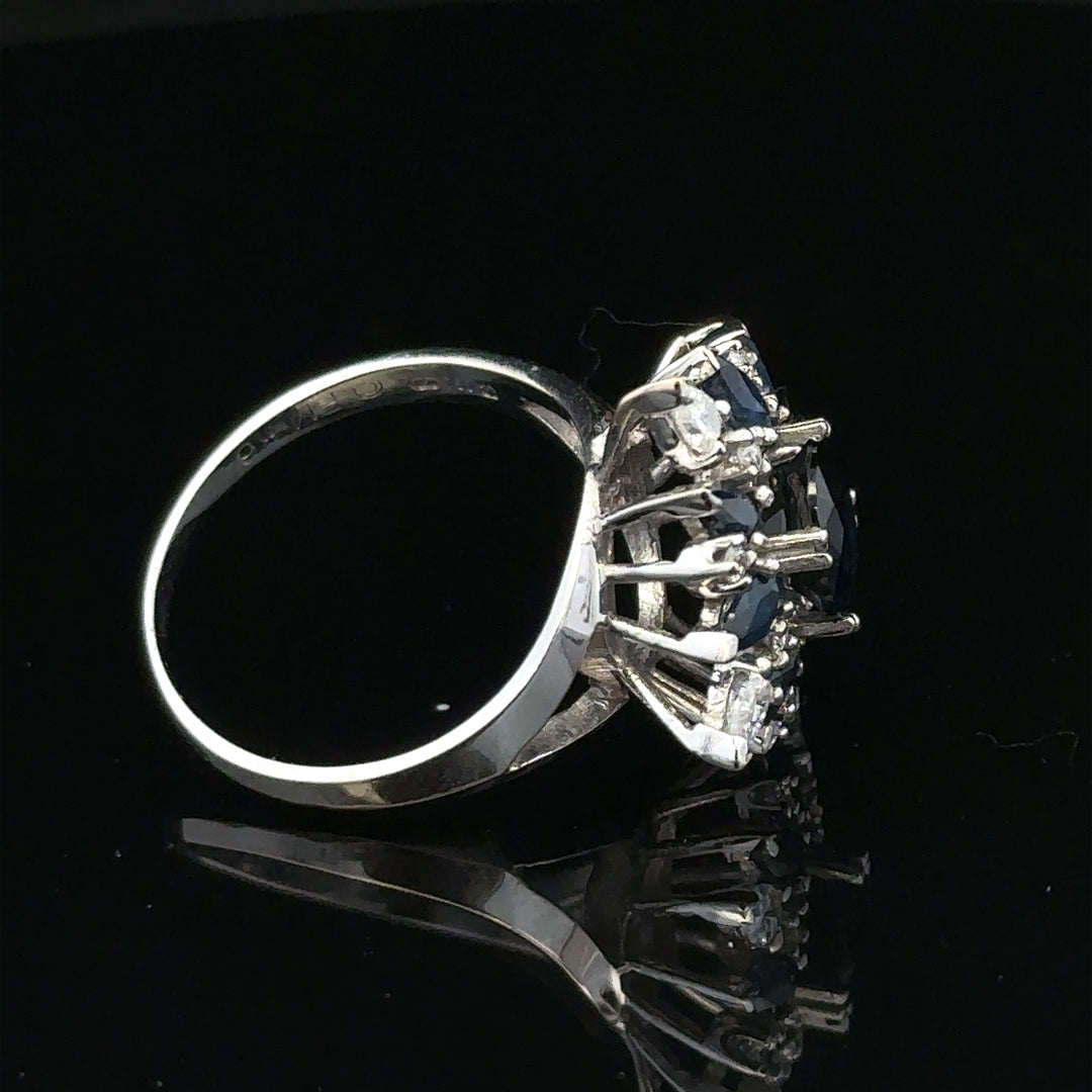 18ct white gold sapphire and diamond ring, size N1/2, featuring a central sapphire surrounded by diamonds with elegant band detailing.
