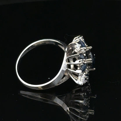 18ct white gold sapphire and diamond ring, size N1/2, featuring a central sapphire surrounded by diamonds with elegant band detailing.