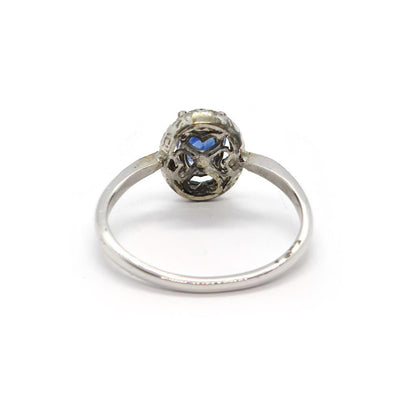18ct white gold sapphire and diamond ring with a central blue sapphire and surrounding diamonds, elegant jewelry piece.