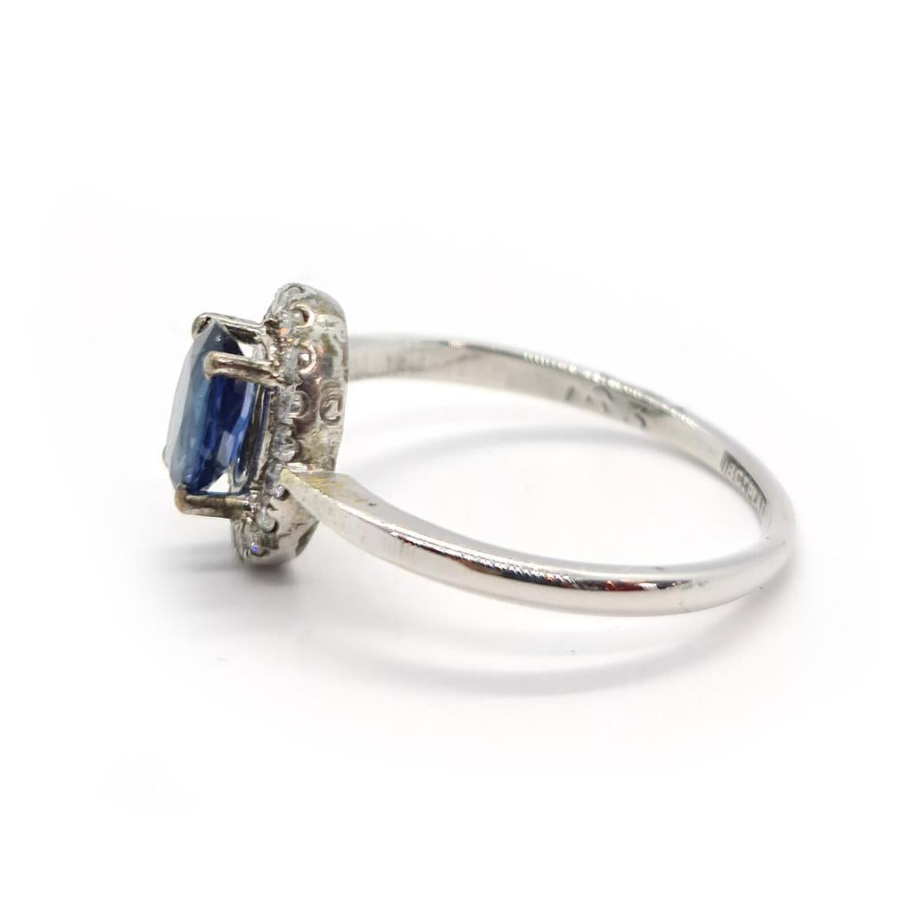 18ct white gold sapphire and diamond ring featuring a central sapphire gemstone with surrounding diamonds, elegant jewelry piece.