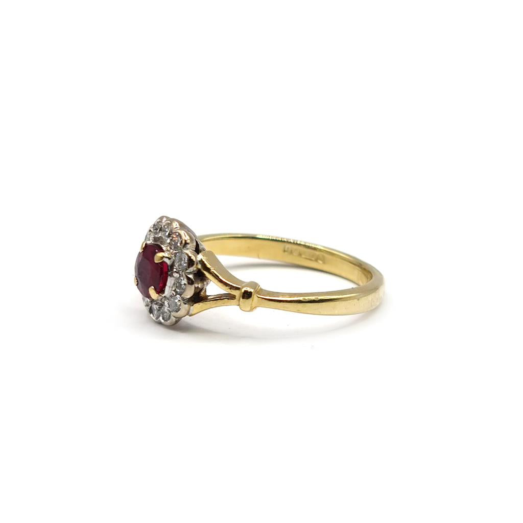 18ct yellow gold ring featuring a 0.33-carat ruby and 1/4-carat diamond, showcasing an elegant and classic jewelry design.
