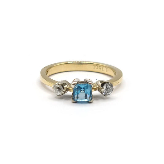 18ct yellow gold ring with a 0.35 carat topaz and 0.14 carat diamond accents, featuring a sleek and elegant design.