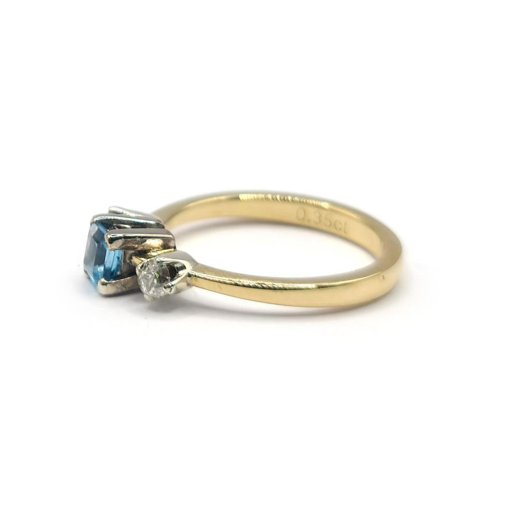18ct yellow gold ring featuring a 0.35 carat blue topaz and 0.14 carat diamond accents, elegant jewelry piece.